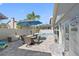 Relaxing poolside patio area features comfortable seating, a dining set, and a vibrant blue umbrella at 4608 Apple Ridge Ln, Tampa, FL 33624