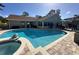 Backyard pool and jacuzzi with brick pavers and updated exterior of the home at 4608 Apple Ridge Ln, Tampa, FL 33624