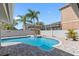 Inviting in-ground pool with brick paver deck, hot tub, and lush tropical landscaping creates a private outdoor oasis at 4608 Apple Ridge Ln, Tampa, FL 33624