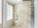 Modern walk-in shower with sleek tile, glass enclosure, and rainfall showerhead at 4608 Apple Ridge Ln, Tampa, FL 33624