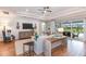 Bright living room with hardwood floors, comfy seating, and sliding glass doors leading to the backyard at 16240 Alpha Grove Pl, Odessa, FL 33556