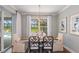 Dining room with wooden table, chandelier, and view of the pool and patio at 16240 Alpha Grove Pl, Odessa, FL 33556
