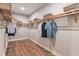 Large walk-in closet with wood shelving and ample hanging space at 16240 Alpha Grove Pl, Odessa, FL 33556