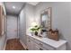 Bright hallway with hardwood floors and a white cabinet with quartz countertop at 16240 Alpha Grove Pl, Odessa, FL 33556