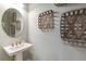 Small powder room with pedestal sink and decorative wall baskets at 16240 Alpha Grove Pl, Odessa, FL 33556