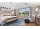Main bedroom with large window, hardwood floors, and sitting area at 16240 Alpha Grove Pl, Odessa, FL 33556