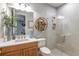 Bathroom with a glass shower, wood vanity, and modern fixtures at 16240 Alpha Grove Pl, Odessa, FL 33556