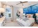 Bedroom with underwater-themed wall and plenty of light at 16240 Alpha Grove Pl, Odessa, FL 33556