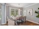 Bright dining room with wooden table, chandelier, and access to a pool view at 16240 Alpha Grove Pl, Odessa, FL 33556