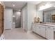 Primary bathroom with a large vanity, granite countertop, and a walk-in shower at 16240 Alpha Grove Pl, Odessa, FL 33556