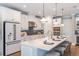Spacious kitchen with white cabinets, quartz countertops, and stainless steel appliances at 16240 Alpha Grove Pl, Odessa, FL 33556