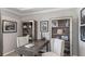 Home office with built-in shelving, a large desk, and comfortable seating at 11178 Manor House Ln, Odessa, FL 33556