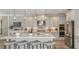 Modern kitchen with stainless steel appliances and a large island with seating at 11178 Manor House Ln, Odessa, FL 33556