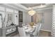 Elegant dining room with a statement chandelier and seating for six at 11178 Manor House Ln, Odessa, FL 33556