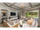 Open-concept living area with coffered ceiling, large windows, and access to the pool area at 11178 Manor House Ln, Odessa, FL 33556