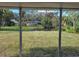 Screened porch overlooking a large backyard with pond view at 18721 Yocam Ave, Lutz, FL 33549