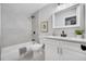 Clean bathroom featuring a shower/tub combo and white cabinetry at 18721 Yocam Ave, Lutz, FL 33549