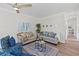 Bright and airy living room with two sofas, coffee table, and ceiling fan at 6435 Finance Ave, Weeki Wachee, FL 34607
