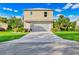 Two-story house with attached garage and landscaped yard at 6435 Finance Ave, Weeki Wachee, FL 34607