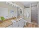 Bathroom with granite countertop vanity, a walk-in shower, and white cabinets at 6435 Finance Ave, Weeki Wachee, FL 34607
