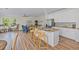 Open concept kitchen features granite countertops, stainless steel appliances, and an island with seating at 6435 Finance Ave, Weeki Wachee, FL 34607