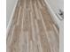Clean and simple hallway with light grey wood-look flooring at 6435 Finance Ave, Weeki Wachee, FL 34607