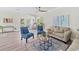 Spacious living room features comfortable seating, a large area rug, and access to a balcony at 6435 Finance Ave, Weeki Wachee, FL 34607