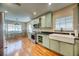 Renovated kitchen with farmhouse sink and light green cabinets at 205 S Occident St, Tampa, FL 33609