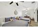 Guest bedroom with two twin beds and ceiling fan at 1906 2Nd St, Indian Rocks Beach, FL 33785