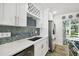 Modern kitchen with white cabinets, stainless steel appliances, and an island at 1906 2Nd St, Indian Rocks Beach, FL 33785