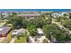 Aerial view of a single-Gathering home with ocean views, lush landscaping, and nearby buildings at 1906 2Nd St, Indian Rocks Beach, FL 33785