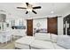 Open concept kitchen with white cabinets, island, and stainless steel appliances at 1906 2Nd St, Indian Rocks Beach, FL 33785
