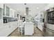 Modern kitchen with white cabinets, stainless steel appliances, and an island at 1906 2Nd St, Indian Rocks Beach, FL 33785