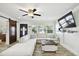 Bright living room featuring a sectional sofa, coffee table, and large TV at 1906 2Nd St, Indian Rocks Beach, FL 33785