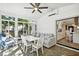 Bright sunroom with backyard view and seating area at 1906 2Nd St, Indian Rocks Beach, FL 33785