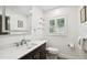 Bright bathroom features a quartz countertop vanity and toilet at 1906 2Nd St, Indian Rocks Beach, FL 33785