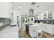 Modern kitchen with white cabinets, stainless steel appliances, and an island at 1906 2Nd St, Indian Rocks Beach, FL 33785
