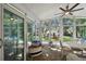 Bright sunroom with backyard view and seating area at 1906 2Nd St, Indian Rocks Beach, FL 33785