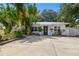 Bright house with tropical landscaping and a spacious driveway at 1906 2Nd St, Indian Rocks Beach, FL 33785