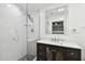 Bathroom with marble shower, quartz countertop vanity, and modern fixtures at 1906 2Nd St, Indian Rocks Beach, FL 33785