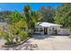 Charming single story home with a metal roof, lush landscaping, and a spacious driveway at 1906 2Nd St, Indian Rocks Beach, FL 33785