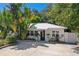 Charming single story home with a metal roof, lush landscaping, and a spacious driveway at 1906 2Nd St, Indian Rocks Beach, FL 33785