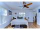 Cozy bedroom with hardwood floors, ceiling fan, and neutral color palette at 2225 Lake Forest Ave, Spring Hill, FL 34609