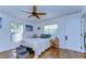 Bright bedroom with hardwood floors, ceiling fan, and large windows at 2225 Lake Forest Ave, Spring Hill, FL 34609