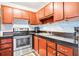 Kitchen with stainless steel appliances and wood cabinets at 1801 Bedford Ln # 27, Sun City Center, FL 33573