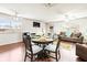 Dining area with a round table and four chairs, adjacent to a living room at 1801 Bedford Ln # 27, Sun City Center, FL 33573