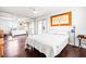 Bright bedroom with a queen-size bed, mirrored closet, and wood floors at 1801 Bedford Ln # 27, Sun City Center, FL 33573