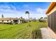 View of the community's grassy backyard and neighboring homes at 1801 Bedford Ln # 27, Sun City Center, FL 33573