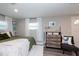 Cozy bedroom with plush bedding, dresser, and window with natural light at 3405 E 33Rd Ave, Tampa, FL 33610