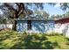 View of backyard shed with large tree overhead at 3405 E 33Rd Ave, Tampa, FL 33610